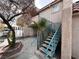 Staircase leads to an upper-level unit, set against a backdrop of palm trees and stucco exterior at 2101 Sun Ave, North Las Vegas, NV 89030