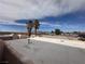Exterior view of the property showing palm trees, buildings, and a blue sky at 2101 Sun Ave, North Las Vegas, NV 89030