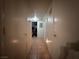 Narrow hallway with neutral walls, tile flooring, and multiple doors at 2101 Sun Ave, North Las Vegas, NV 89030