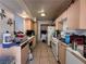 Kitchen featuring wood cabinets, tile flooring, and older appliances at 2101 Sun Ave, North Las Vegas, NV 89030