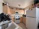 Kitchen featuring white appliances, tile flooring, and light wood cabinets at 2101 Sun Ave, North Las Vegas, NV 89030