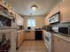 Functional kitchen featuring tile flooring, essential appliances, and ample storage space at 2101 Sun Ave, North Las Vegas, NV 89030