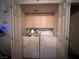 Laundry room featuring a washer, a dryer, and built-in shelving at 2101 Sun Ave, North Las Vegas, NV 89030