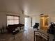 Bright living room featuring tile flooring, a brown couch, and access to multiple rooms at 2101 Sun Ave, North Las Vegas, NV 89030