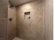 Modern tiled shower with a built-in niche for toiletries, offering style and convenience at 2101 Sun Ave, North Las Vegas, NV 89030
