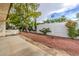Secluded backyard with a patio and vibrant landscaping perfect for relaxation and entertaining at 2579 La Fortuna Ave, Las Vegas, NV 89121