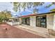Charming backyard patio with mature trees and an easy-to-maintain rock landscape and sliding glass doors at 2579 La Fortuna Ave, Las Vegas, NV 89121