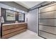 Contemporary bathroom features a double vanity and a large sliding glass door at 2579 La Fortuna Ave, Las Vegas, NV 89121