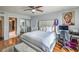 Bright bedroom features hardwood floors, ceiling fan, desk, and a decorative painting at 2579 La Fortuna Ave, Las Vegas, NV 89121