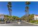 Gated community entrance with mature palm trees and landscaping on a sunny day at 2579 La Fortuna Ave, Las Vegas, NV 89121