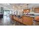 Open kitchen with breakfast bar, stainless steel appliances, modern lighting, and view to the outdoor patio at 2579 La Fortuna Ave, Las Vegas, NV 89121