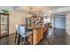Beautiful kitchen showcasing a large island with granite countertop, chairs and stylish pendant lighting at 2579 La Fortuna Ave, Las Vegas, NV 89121