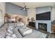 Spacious living room featuring a fireplace, a large sectional sofa, and an open-concept design with a view into the kitchen at 2579 La Fortuna Ave, Las Vegas, NV 89121