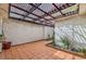 Enclosed patio with tiled floor, decorative pergola and string lights at 2579 La Fortuna Ave, Las Vegas, NV 89121