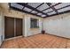 Enclosed patio with tiled floor, decorative pergola and string lights at 2579 La Fortuna Ave, Las Vegas, NV 89121