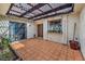 Enclosed patio with tiled floor, decorative pergola and string lights at 2579 La Fortuna Ave, Las Vegas, NV 89121