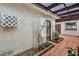 Enclosed patio with tiled floor, decorative pergola and string lights at 2579 La Fortuna Ave, Las Vegas, NV 89121