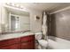 Bathroom with a toilet, bathtub, sink, and mirror at 2606 S Durango Dr # 232, Las Vegas, NV 89117