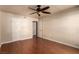 Large bedroom with white walls, hardwood floor, and a ceiling fan at 2606 S Durango Dr # 232, Las Vegas, NV 89117