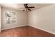 Bedroom with a ceiling fan, window, and hardwood floor at 2606 S Durango Dr # 232, Las Vegas, NV 89117