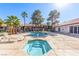 Community pool and hot tub surrounded by desert landscaping and lounge seating at 2606 S Durango Dr # 232, Las Vegas, NV 89117