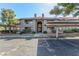 Exterior view of the condo featuring a terracotta tile roof, covered parking and desert landscaping at 2606 S Durango Dr # 232, Las Vegas, NV 89117