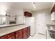Bright kitchen with granite counters, white appliances, and view of an adjacent living area with fireplace at 2606 S Durango Dr # 232, Las Vegas, NV 89117
