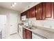 Cozy kitchen featuring granite countertops, stainless steel sink, and updated appliances at 2606 S Durango Dr # 232, Las Vegas, NV 89117