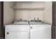 Convenient laundry area features a white washer and dryer unit with shelving at 2606 S Durango Dr # 232, Las Vegas, NV 89117