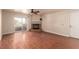 A spacious living room with a sliding glass door to the balcony, a fireplace, wood floors and a ceiling fan at 2606 S Durango Dr # 232, Las Vegas, NV 89117