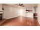 Open concept living room with wood floors, a ceiling fan, a fireplace and a partial view of the kitchen at 2606 S Durango Dr # 232, Las Vegas, NV 89117