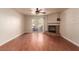 An open concept living room featuring a sliding glass door, wood floors, a ceiling fan and a fireplace at 2606 S Durango Dr # 232, Las Vegas, NV 89117