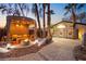 Backyard cabana with an outdoor seating area and fire pit at dusk at 2818 E Quail Ave, Las Vegas, NV 89120