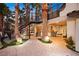 Expansive backyard with a built-in bar, exterior string lights, and lush tropical plants at 2818 E Quail Ave, Las Vegas, NV 89120