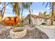 Backyard with outdoor sauna, stone fire pit, and exterior view of the pool house at 2818 E Quail Ave, Las Vegas, NV 89120