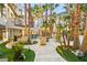 Expansive backyard with lush landscaping, stone pathways, multiple conversation areas, and a complete outdoor bar at 2818 E Quail Ave, Las Vegas, NV 89120