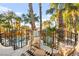 Relaxing balcony view showcasing wrought iron railing and overlooking a stunning backyard pool area lined with palm trees at 2818 E Quail Ave, Las Vegas, NV 89120