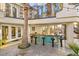 Outdoor bar with seating and granite counters, surrounded by a tropical landscape at 2818 E Quail Ave, Las Vegas, NV 89120