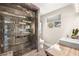 Bathroom features a large glass shower with stone floors and marble countertops at 2818 E Quail Ave, Las Vegas, NV 89120