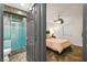 Modern bathroom boasts a luxurious glass-enclosed shower with vibrant blue tiles, next to the bedroom at 2818 E Quail Ave, Las Vegas, NV 89120