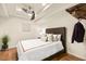 Charming bedroom boasts a cozy bed with soft pillows, modern ceiling fan, and closet space at 2818 E Quail Ave, Las Vegas, NV 89120