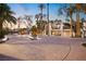 Grand circular driveway with a fountain leading to an elegant home with lush palm trees and landscaping at 2818 E Quail Ave, Las Vegas, NV 89120