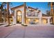 Beautiful home with a stucco facade, tiled roof, palm trees, and a cozy patio with outdoor seating at 2818 E Quail Ave, Las Vegas, NV 89120