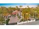 Exterior view of the house and circular driveway featuring mature trees and a decorative fountain at 2818 E Quail Ave, Las Vegas, NV 89120