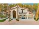 Elegant exterior elevation features an arched entrance, balcony, and manicured landscaping at 2818 E Quail Ave, Las Vegas, NV 89120