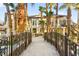 Back exterior showcasing wrought iron staircase to the second floor with a bridge leading to the backyard at 2818 E Quail Ave, Las Vegas, NV 89120