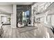 Modern foyer featuring a dramatic spiral staircase, large windows and stylish decor at 2818 E Quail Ave, Las Vegas, NV 89120