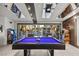 Game room showcases a pool table and sliding glass doors to the backyard and pool at 2818 E Quail Ave, Las Vegas, NV 89120