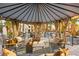 Comfortable gazebo includes seating area with coffee table and views of the manicured backyard at 2818 E Quail Ave, Las Vegas, NV 89120