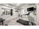 Home gym featuring a punching bag, treadmill, television, and window with natural light at 2818 E Quail Ave, Las Vegas, NV 89120